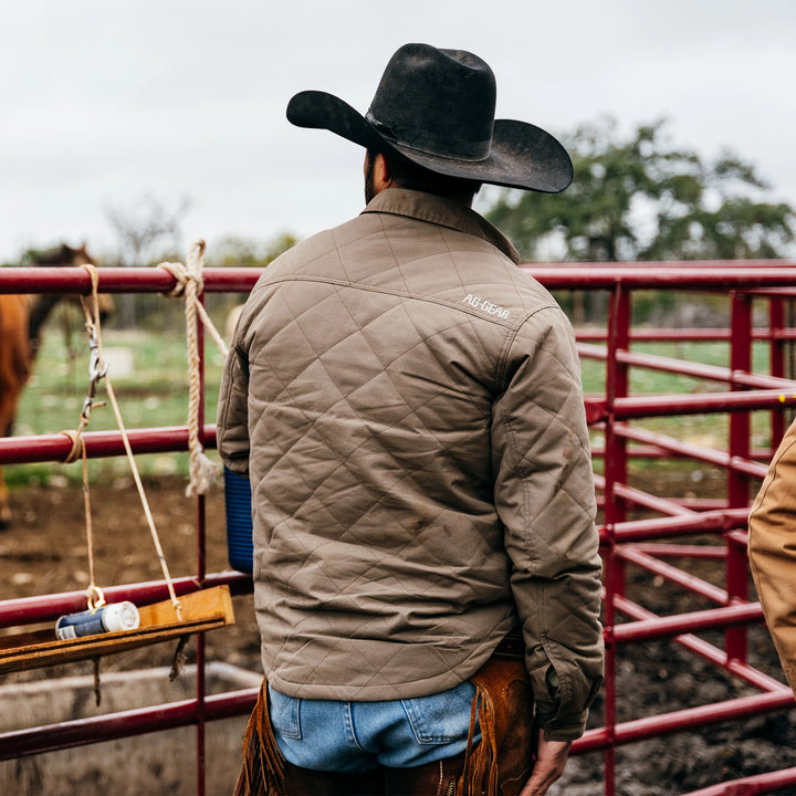 waxed cotton field jacket farm jacket ranch jacket in brown on ranch with cattle gates