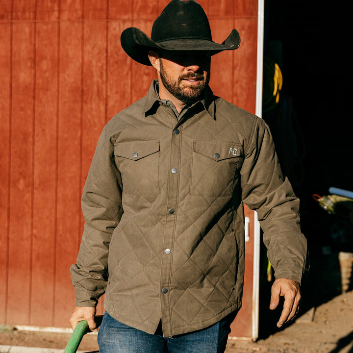 waxed cotton field jacket farm jacket ranch jacket in brown on farm red barn and cowboy hat