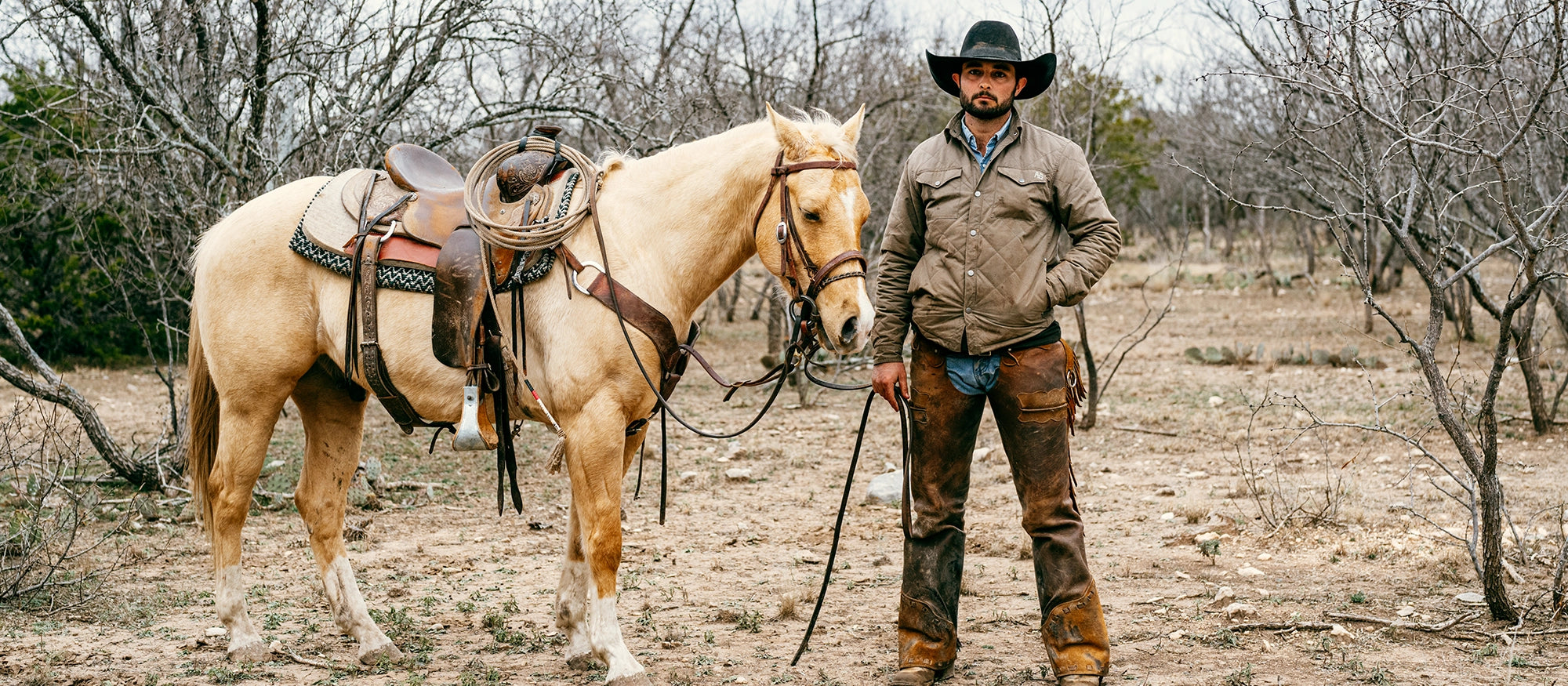 Dillinger waxed cotton field jacket on a ranch with horse and cowboy ranch jacket