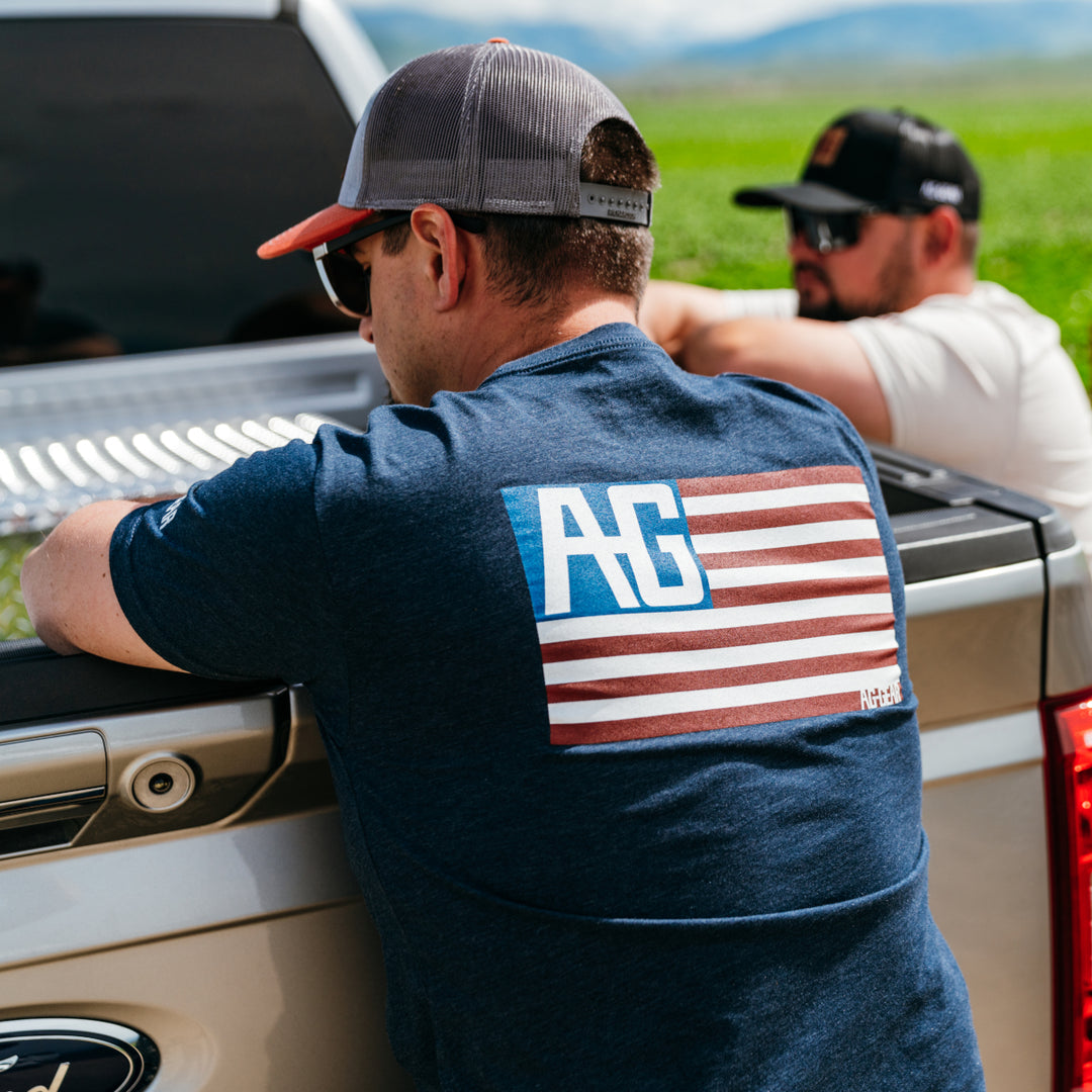 AG American flag graphic on navy cotton teeshirt farm shirt back of pickup